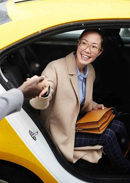 Passenger smiling while greeting driver during Dammam to Bahrain taxi ride, showing comfort and professionalism.