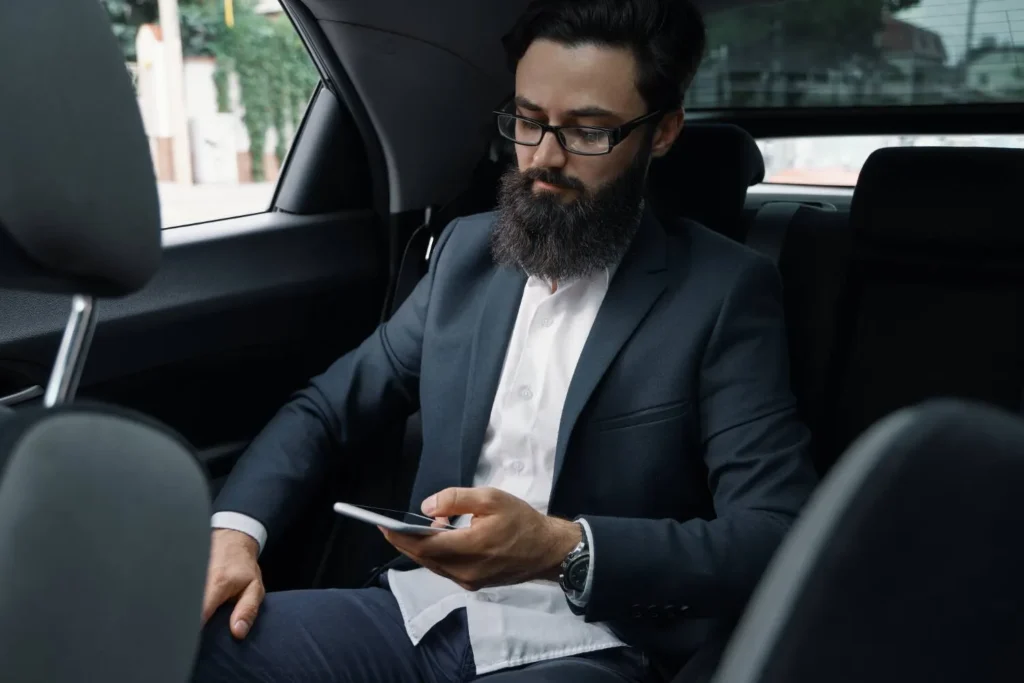 Business traveler enjoying comfortable Taxi Riyadh to Bahrain.